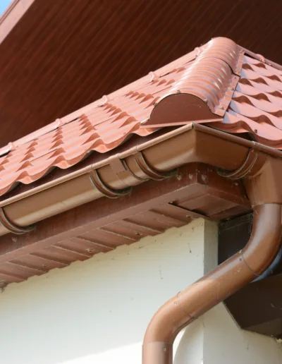 The roof of a house with a brown tiled roof.